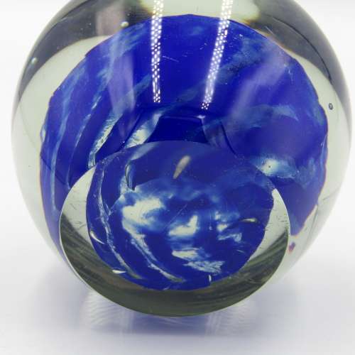 Vintage glass paperweight with blue design