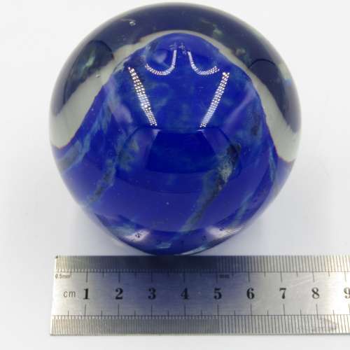 Vintage glass paperweight with blue design