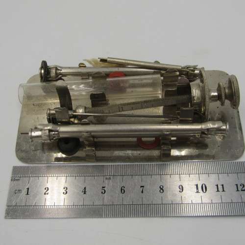 Vintage glass syringe set in metal tin