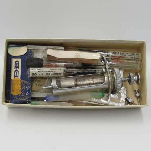 Vintage glass syringe with sealed Anacap Silk stitches in glass tubes