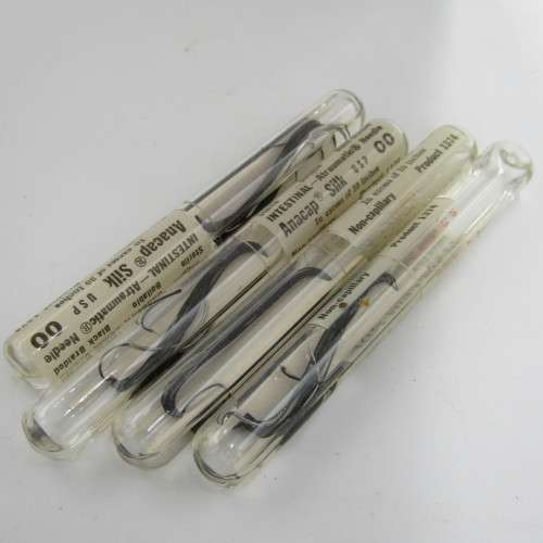 Vintage glass syringe with sealed Anacap Silk stitches in glass tubes