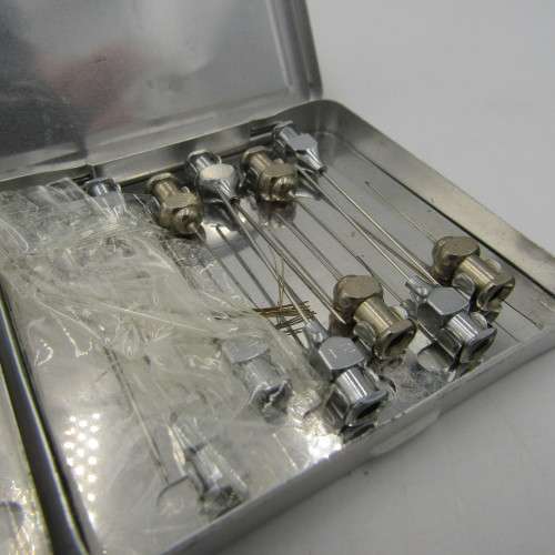 The New Everett glass syringe in box with 2 tins of needles