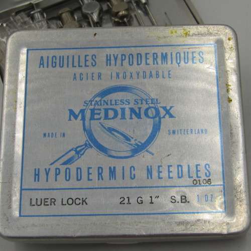 The New Everett glass syringe in box with 2 tins of needles