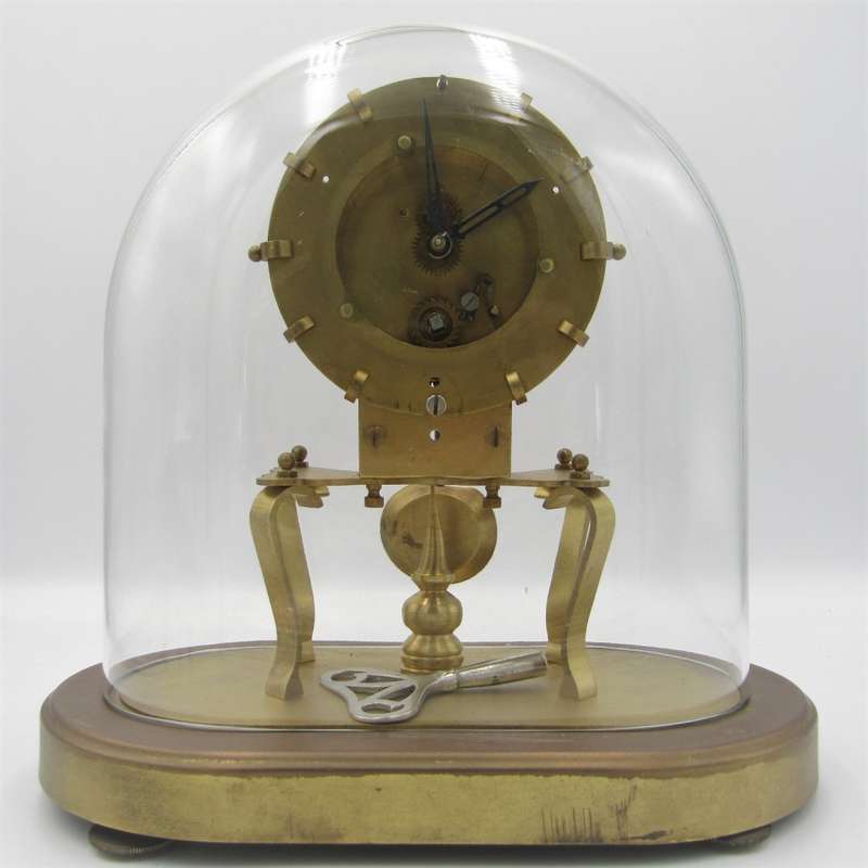 Antique brass skeleton clock with glass dome