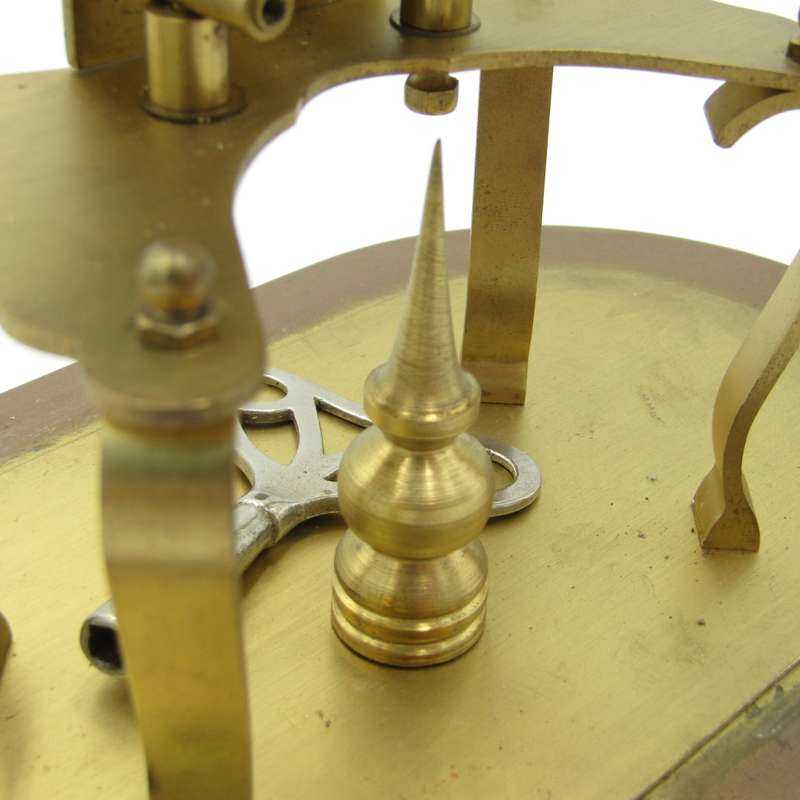 Antique brass skeleton clock with glass dome