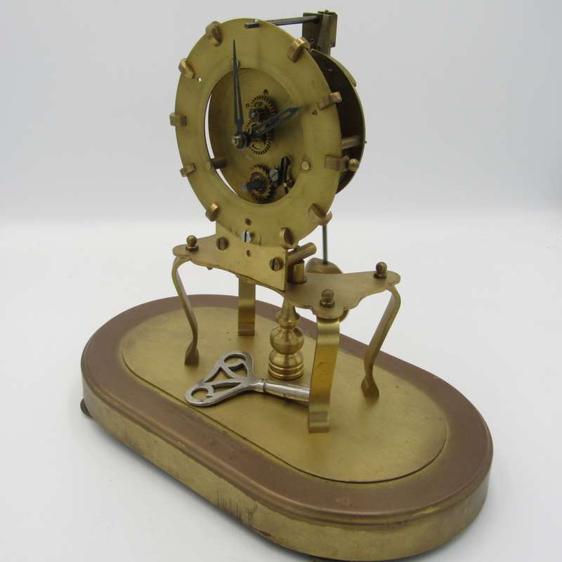 Antique brass skeleton clock with glass dome