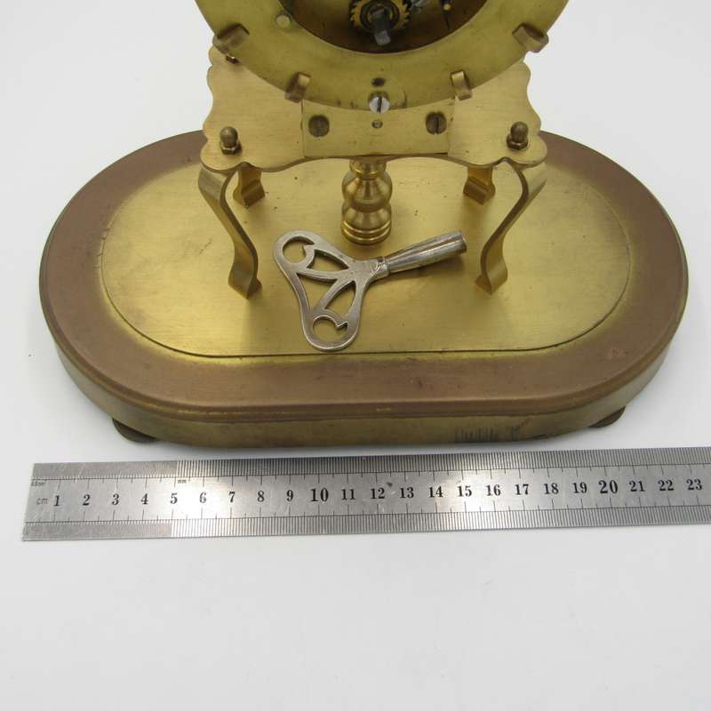 Antique brass skeleton clock with glass dome