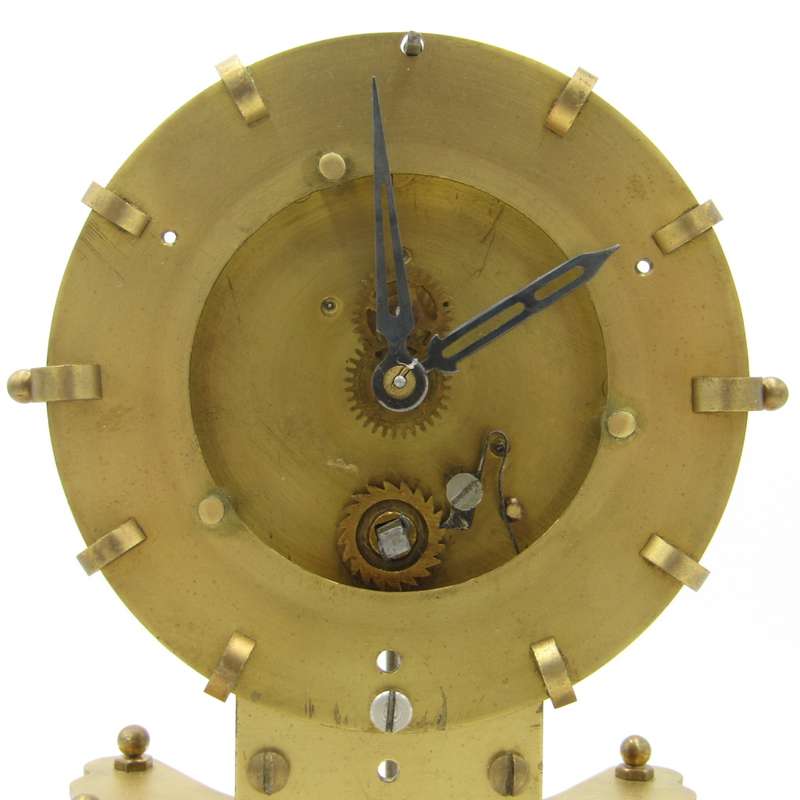 Antique brass skeleton clock with glass dome