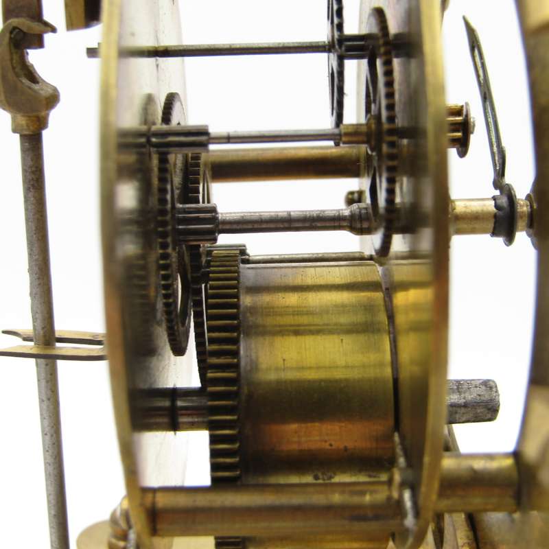 Antique brass skeleton clock with glass dome