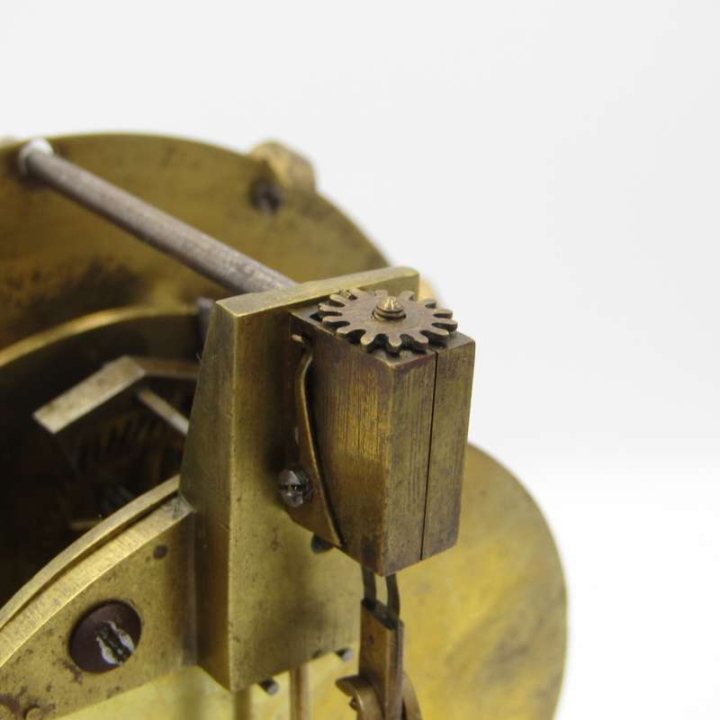 Antique brass skeleton clock with glass dome