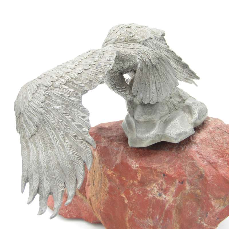 Beautiful white metal eagle sculpture on stone base