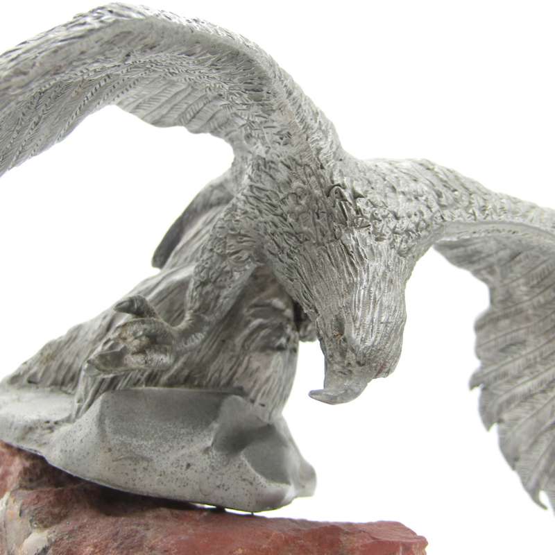 Beautiful white metal eagle sculpture on stone base