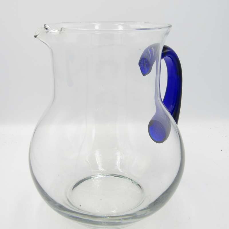 Vintage glass pitcher with blue handle