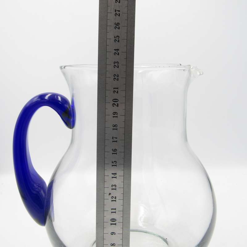 Vintage glass pitcher with blue handle