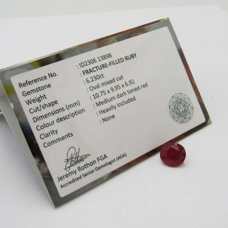 Fracture filled Ruby of 6,2 carat oval mixed cut - dark toned red with Gemlab certificate