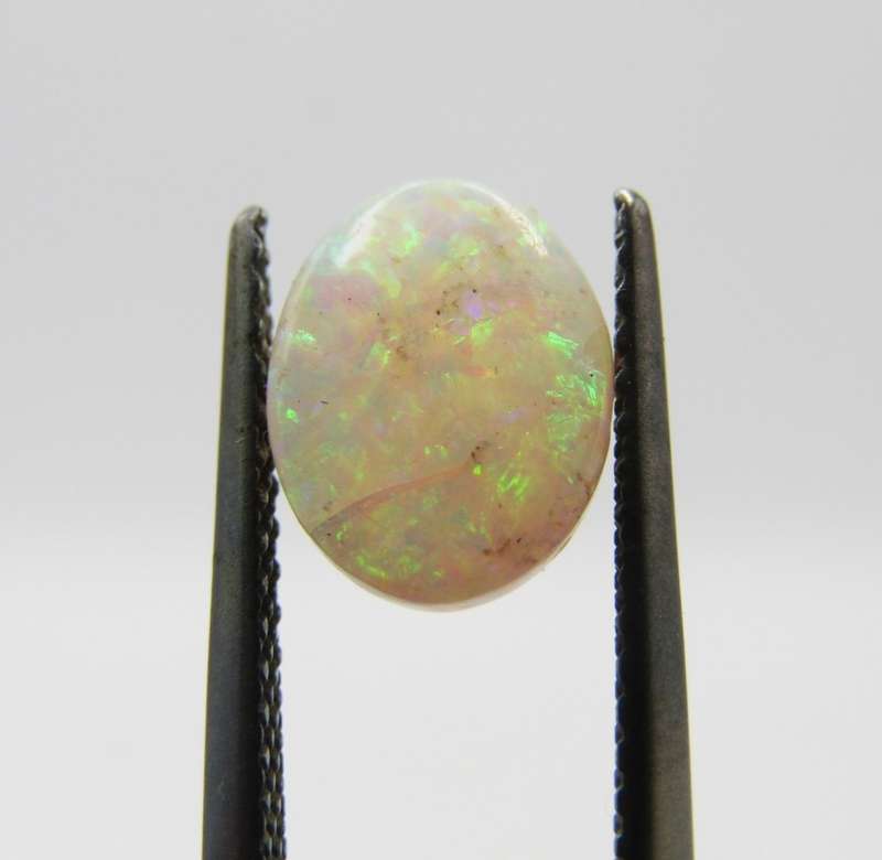 Beautiful orange & green flashes Opal of 1,21 carat - Oval Cabochon white opal
