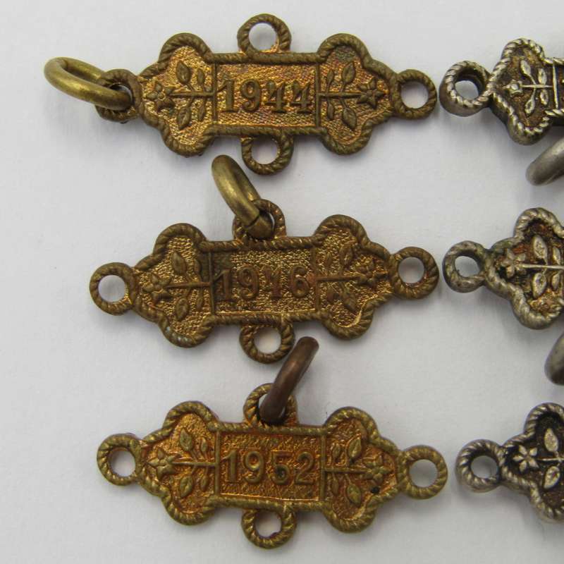Lot of 9 St John`s Ambulance date labels - some silver