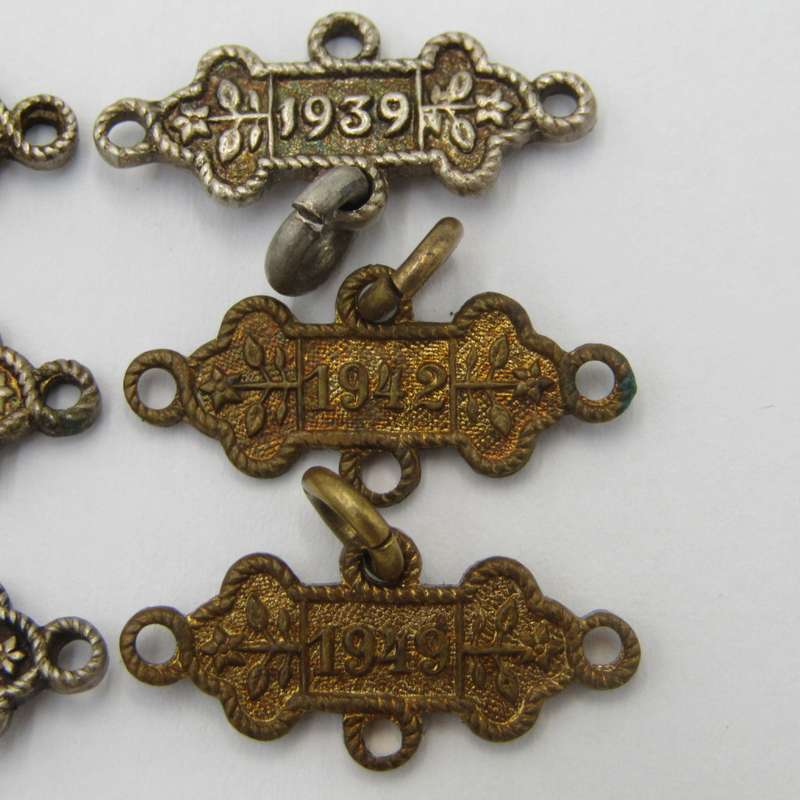 Lot of 9 St John`s Ambulance date labels - some silver