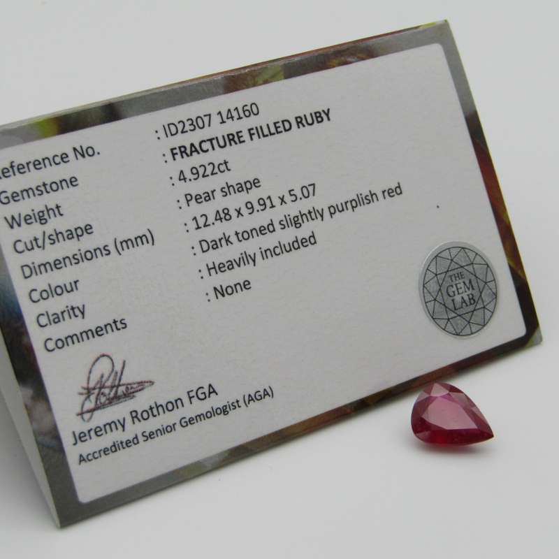 Dark toned slightly purplish red Ruby - fracture filled - 4,92 carat Pear shape