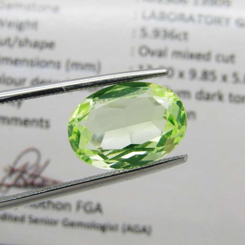 Lab grown Spinel of 5,936 carat - oval mixed cut - Medium dark toned yellowish green