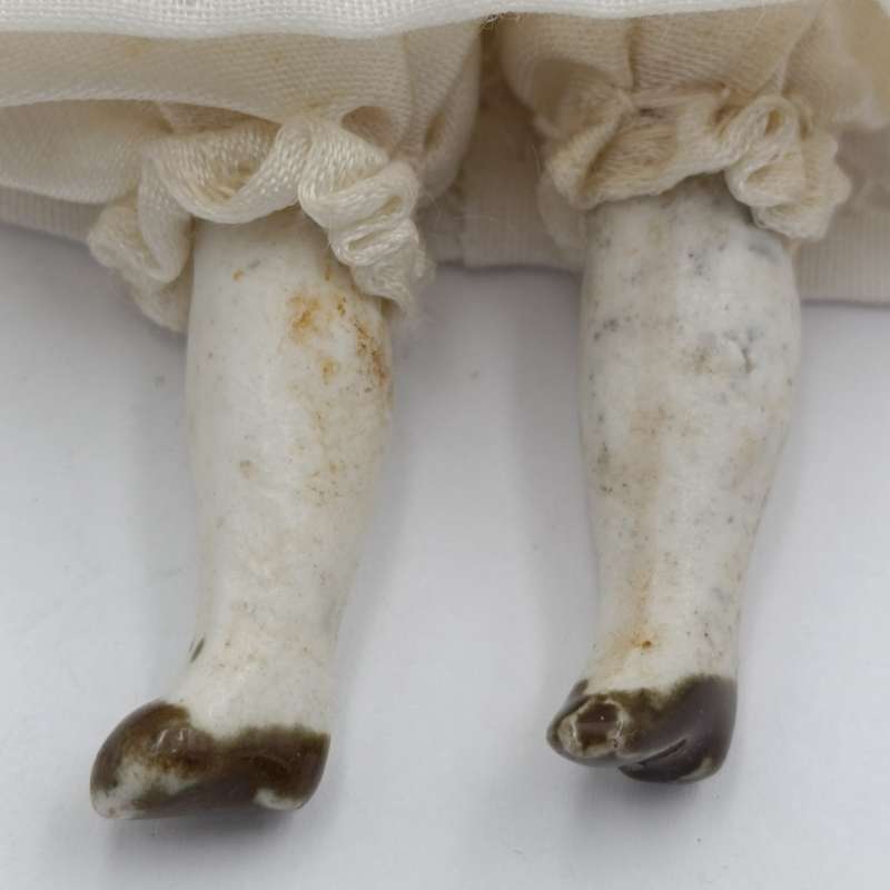 Antique Bisque doll 20cm long - hat chipped - late 1800's