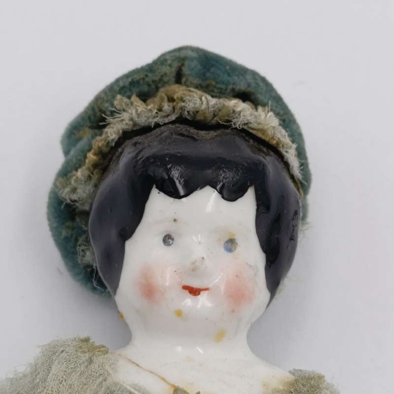 Antique Brown hair rosy cheeks German doll with hat - late 1800's - 18cm long