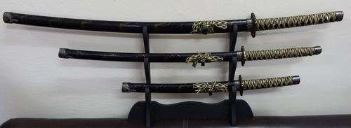 Replica Katana set of swords on wooden stand - as per photo