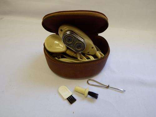 Vintage Philishave electrical razor in leather bag with cleaning tools