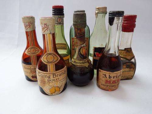 Lot of 8 Vintage miniature liquor bottles still sealed with labels intact contents partly evaporated