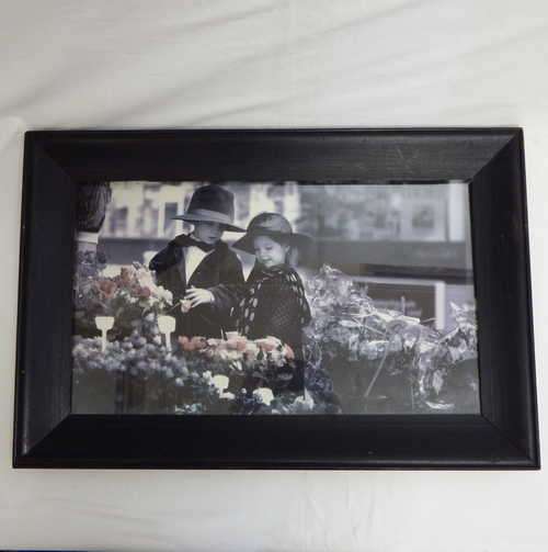Framed picture of little boy and girl at a flower market