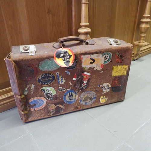 Brown leather suitcase with hotel advertisement stickers - 65x37x19 cm (suitcase has some damage)