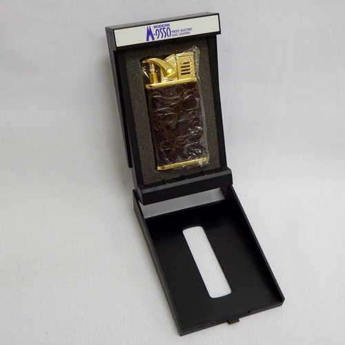 Brass and leather gas lighter in plastic case - Still new (8317A)