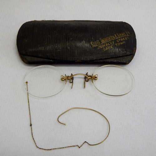 Pair of gold plated frameless pincher glasses with earpiece - in case