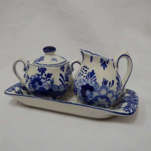 Hand painted Delfts Blue milk jug and sugar pot on tray