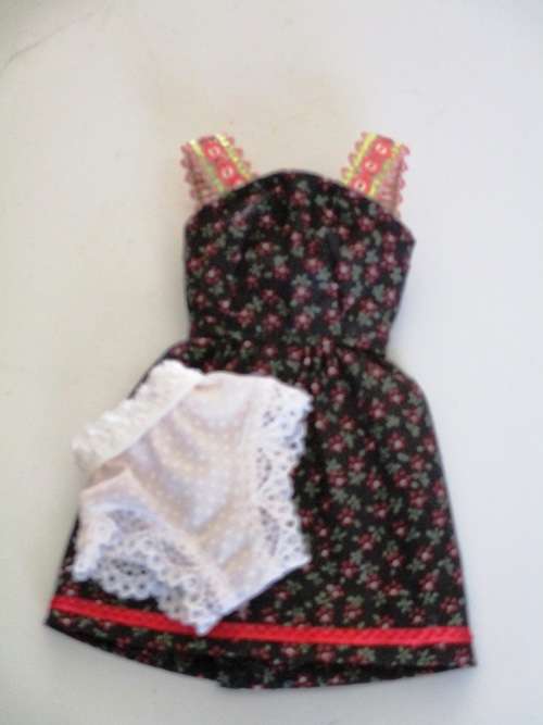 Barbie dress with sequin trim straps. Black and red print.