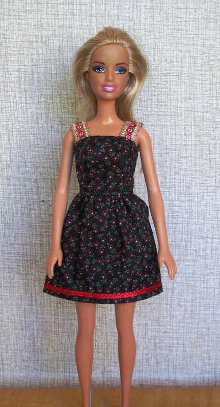 Barbie dress with sequin trim straps. Black and red print.