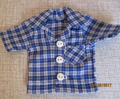 Ken - Barbie white fitted pants with collared button through blue check shirt.