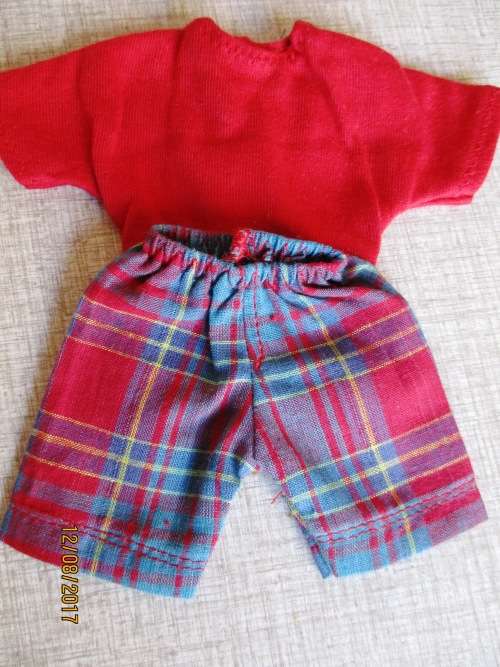 Ken - Barbie - check shorts with red T-shirt.