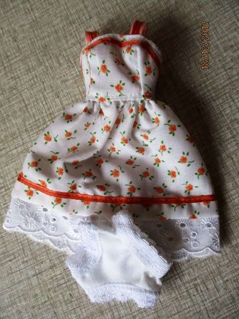 Barbie summer dress with orange trim.