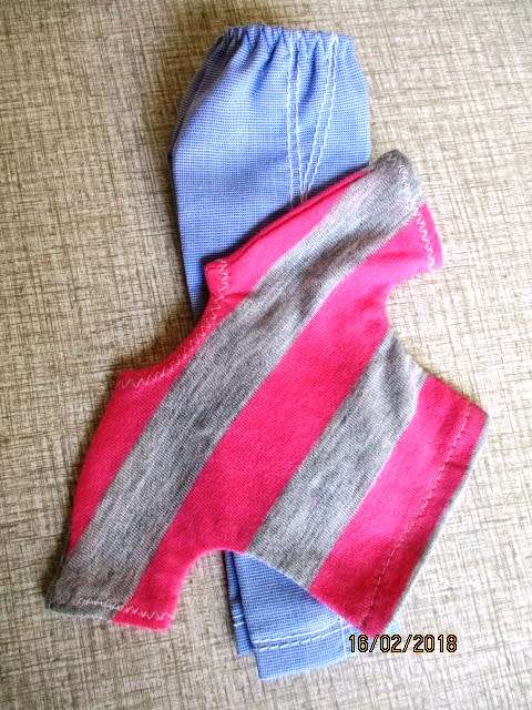 Ken - Barbie - light blue pants plus pink and grey stripe T-shirt.