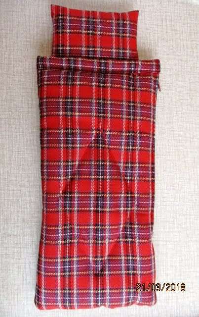 Ken sleeping bag in red check.
