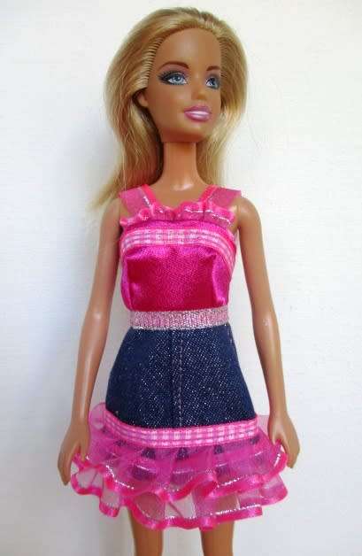 Barbie doll`s denim and pink ribbon dress