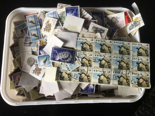 Ice cream tub full of off paper South Africa stamps R1 start