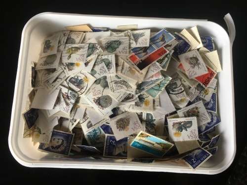 Ice cream tub full of off paper South Africa stamps R1 start