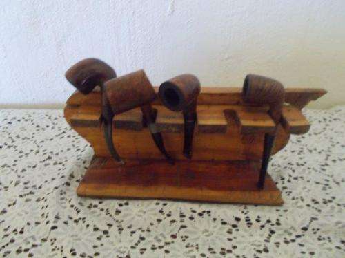 A wooden holder with four named collectable pipes