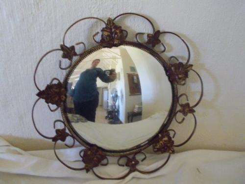 Round convex wall mirror with a ornate wire rim