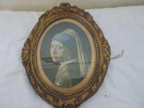Vintage ornate  oval frame with print of a woman behind glass