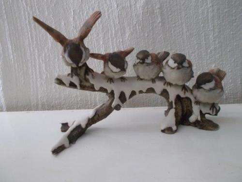 Stunning porcelain birds figurine on a branch