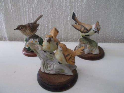 a lot of three nice porcelain birds on wooden stands