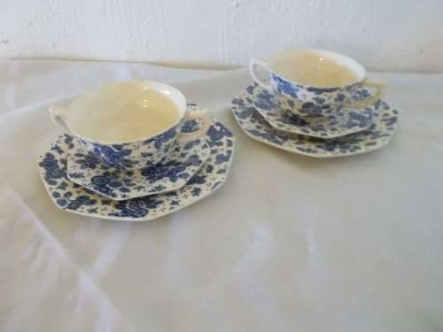 A pair of blue and white floral pattern soup mugs with saucers and side plate set